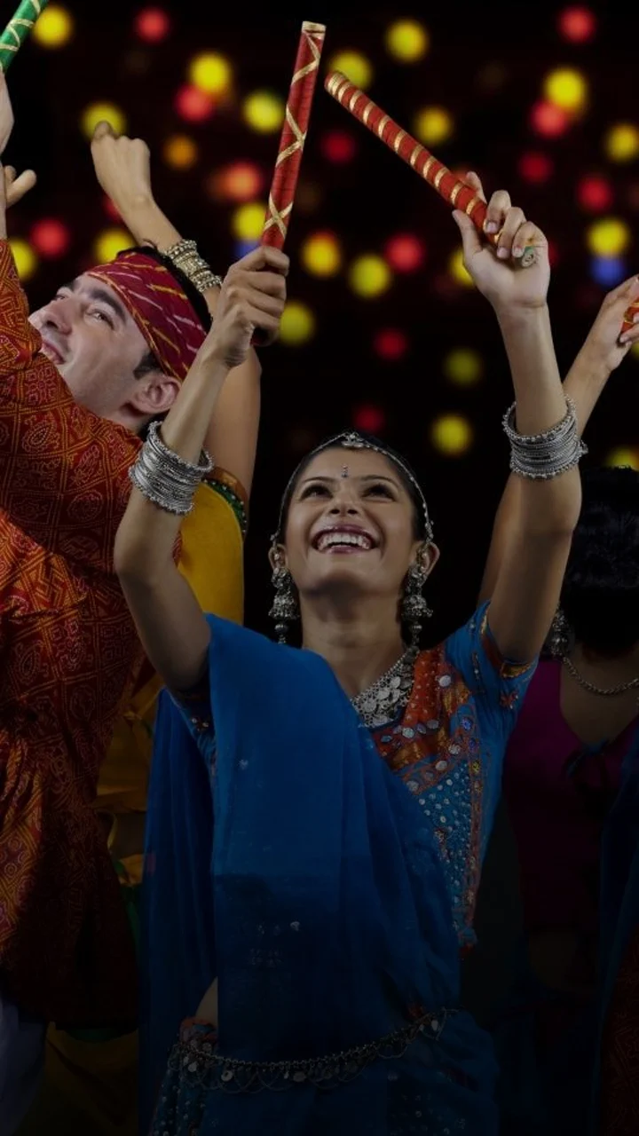 Back view of Indian woman dancing with dandiya stick. 27617538 Vector Art  at Vecteezy